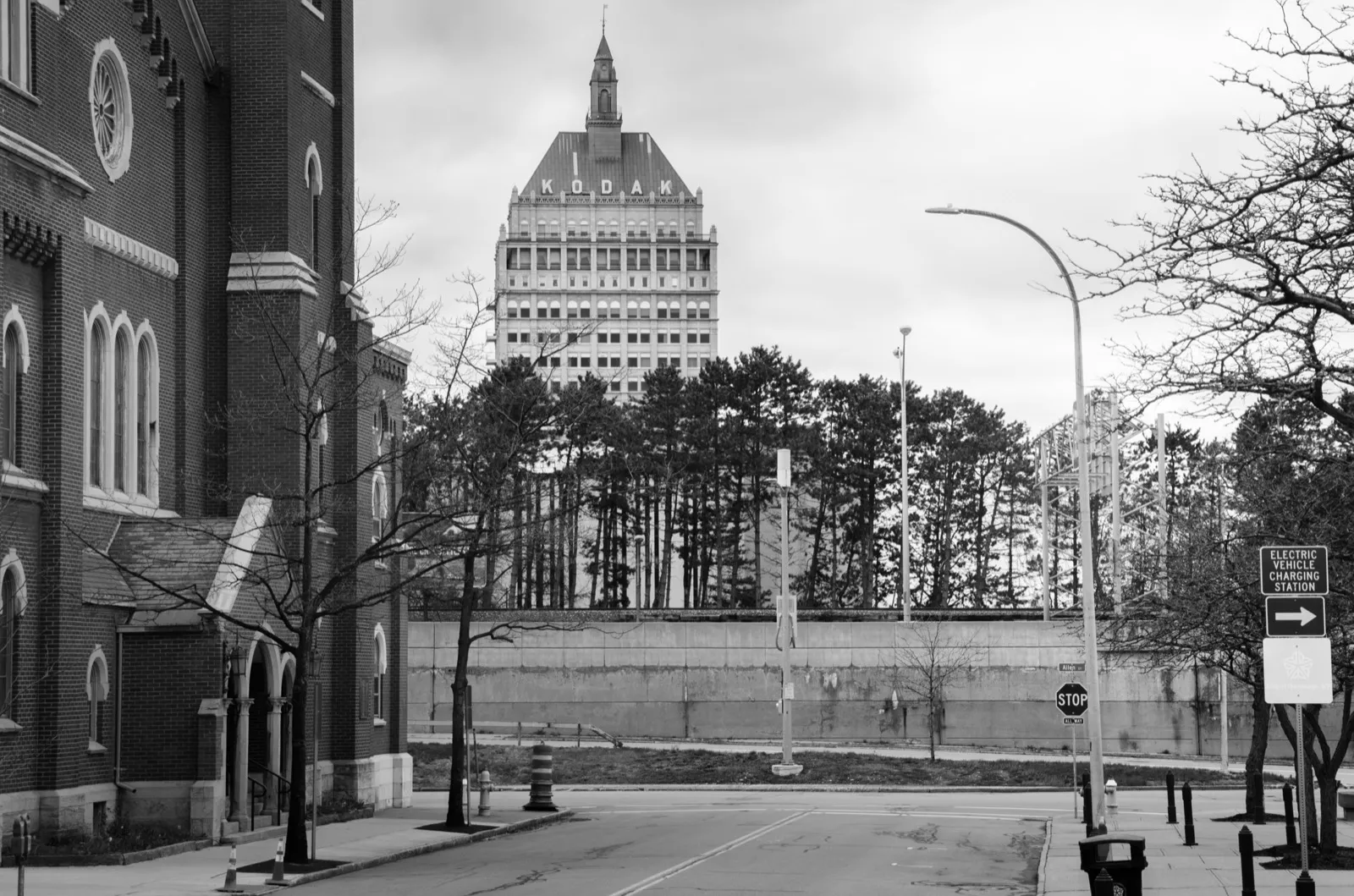 The Kodak Tower rising over a brick church on State Street in Rochester, NY